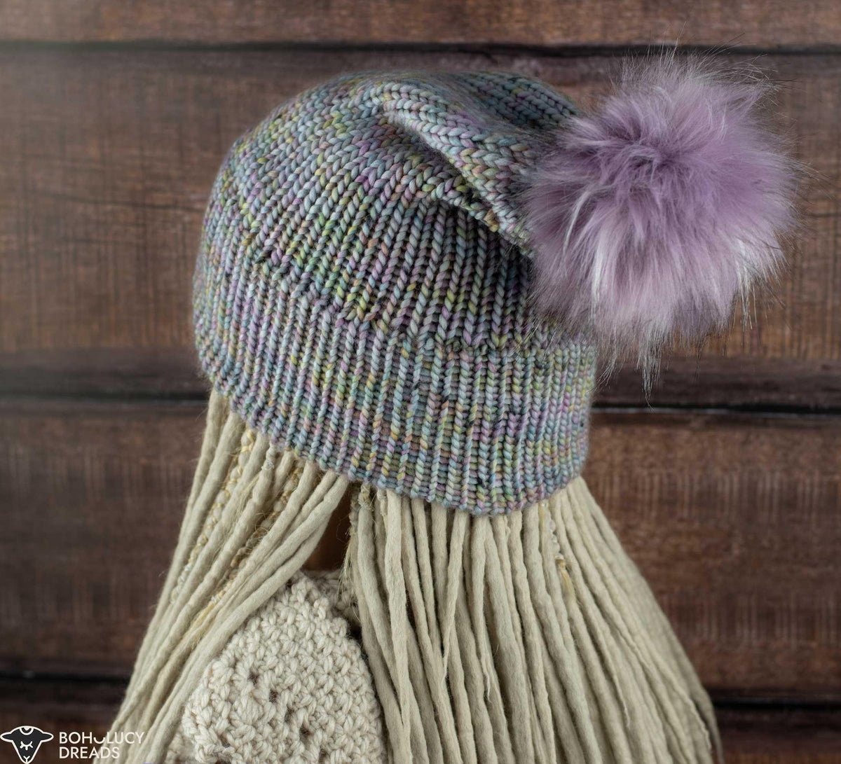 purple slouchy knitted beanie on a dreadlocked head